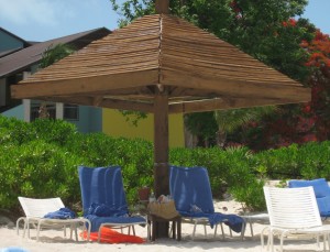 Beach chairs under umbrella in the Caribbean